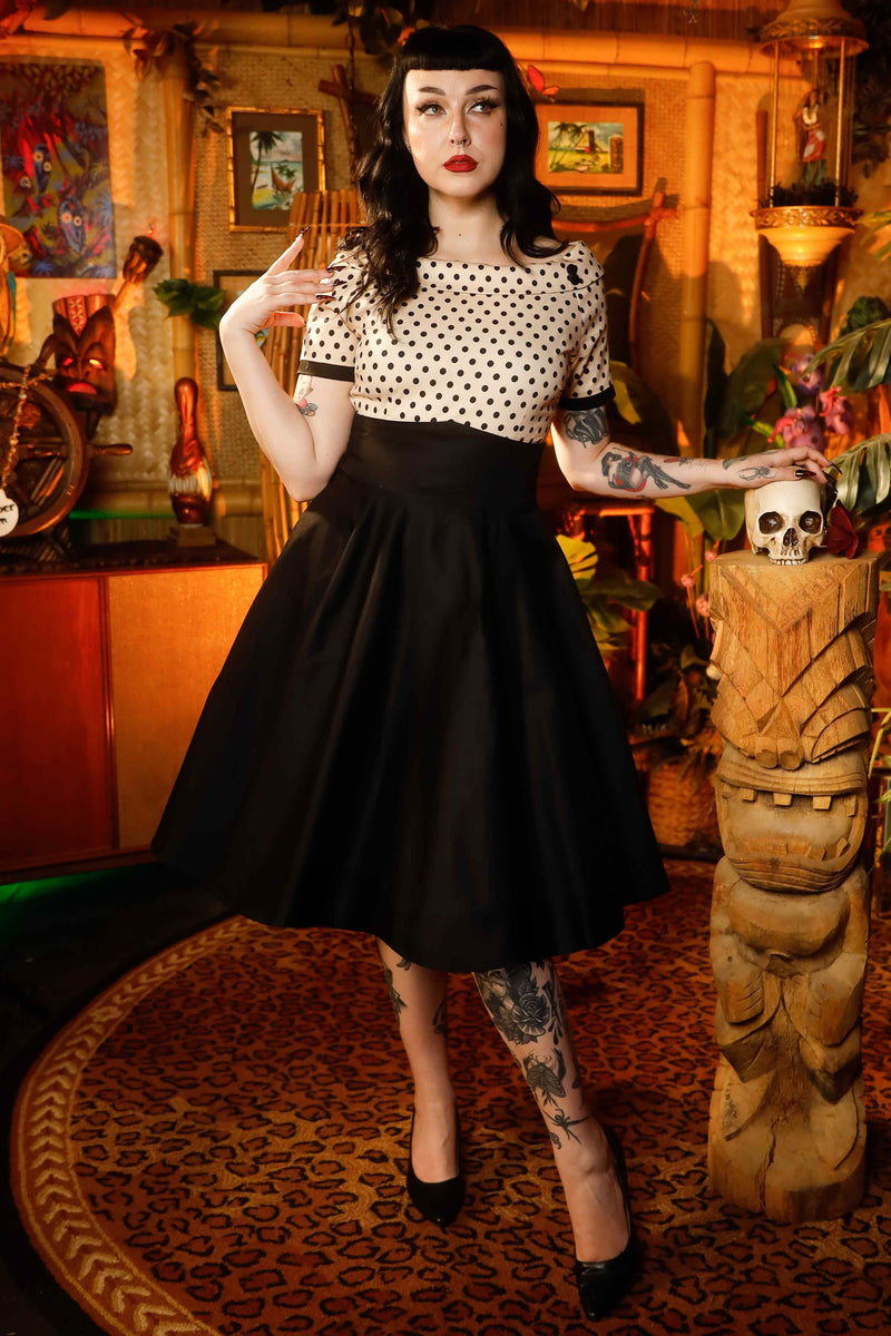 A model wearing a Retro Polka Swing Dress in Beige-Black