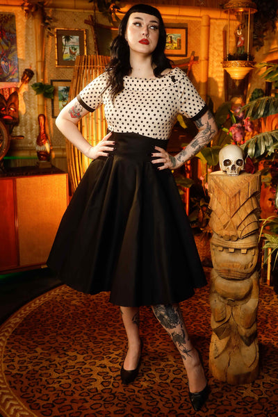 A model wearing a Retro Polka Swing Dress in Beige-Black