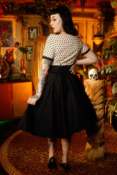 A model wearing a Retro Polka Swing Dress in Beige-Black