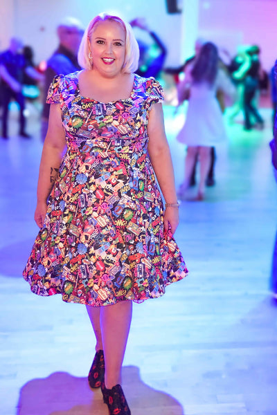Customer wears our cap sleeved Claudia dress in pop art comic strip print