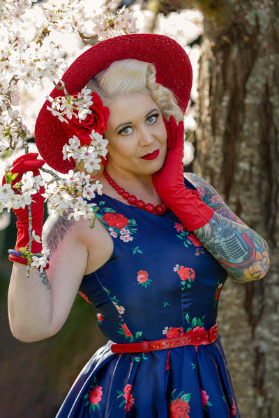 A model wearing Retro Swing Dress in Purple with Raising Rose Print