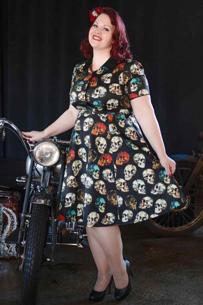 A model in Penelope Rockabilly Black Skull Shirt Dress