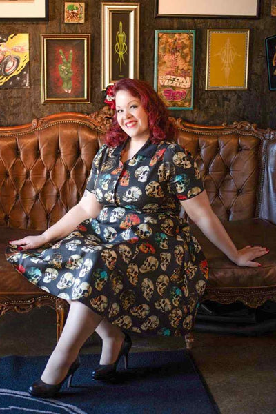 A lady wearing a Rockabilly Black Skull Shirt Dress