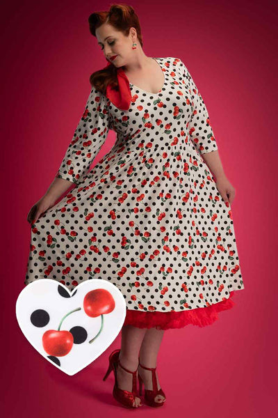 A model wearing a Rockabilly Cherry Polka Dot Dress