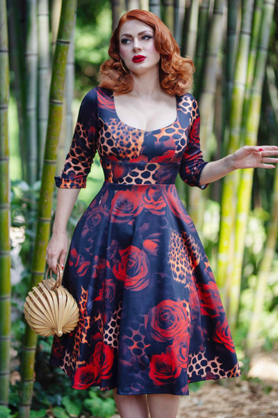 A model wearing a ockabilly Leopard Rose Midi Dress