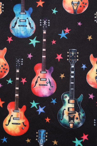 Close up view of Black Pleated Dress in Guitar & Stars Print