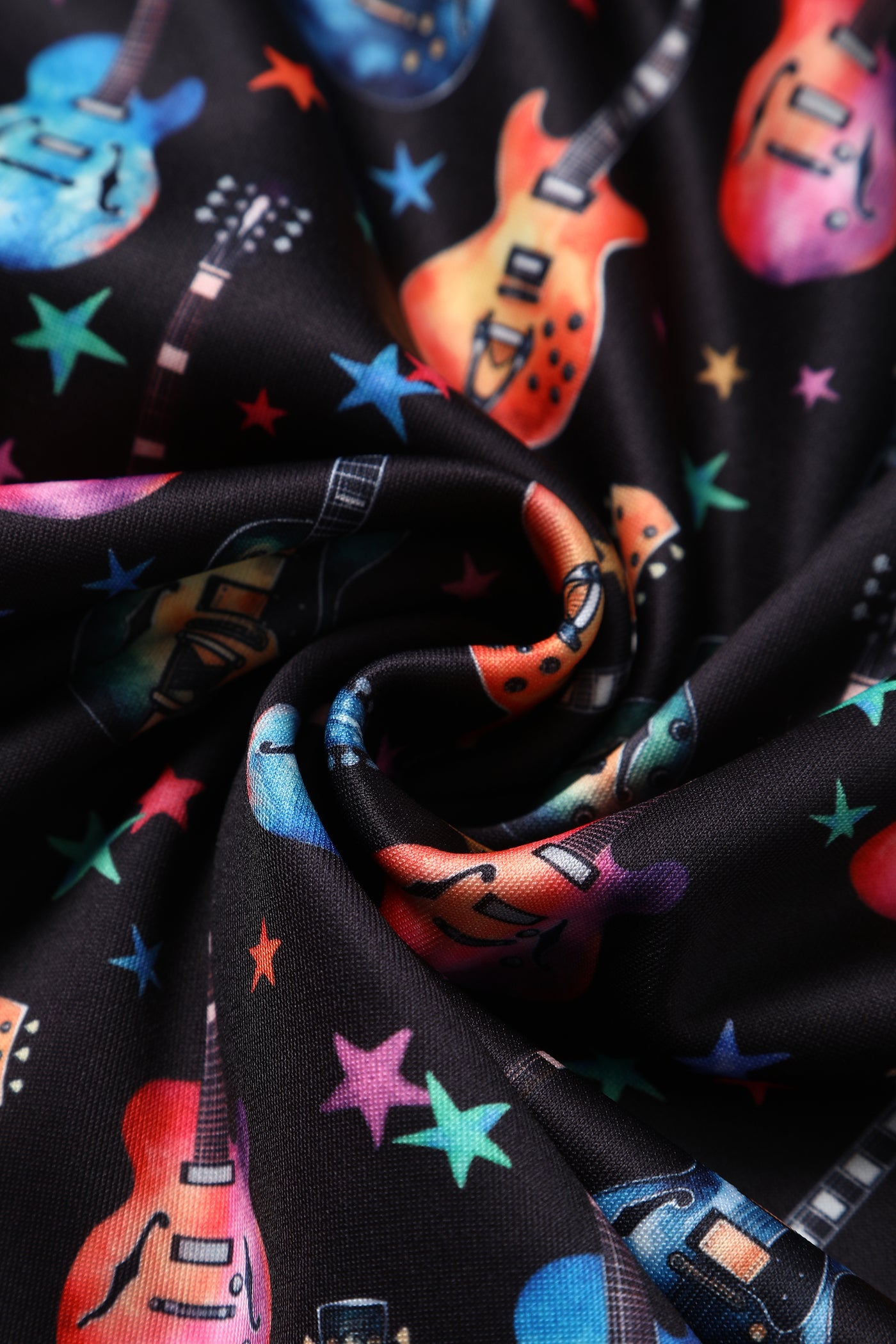 Close up view of Black Pleated Dress in Guitar & Stars Print