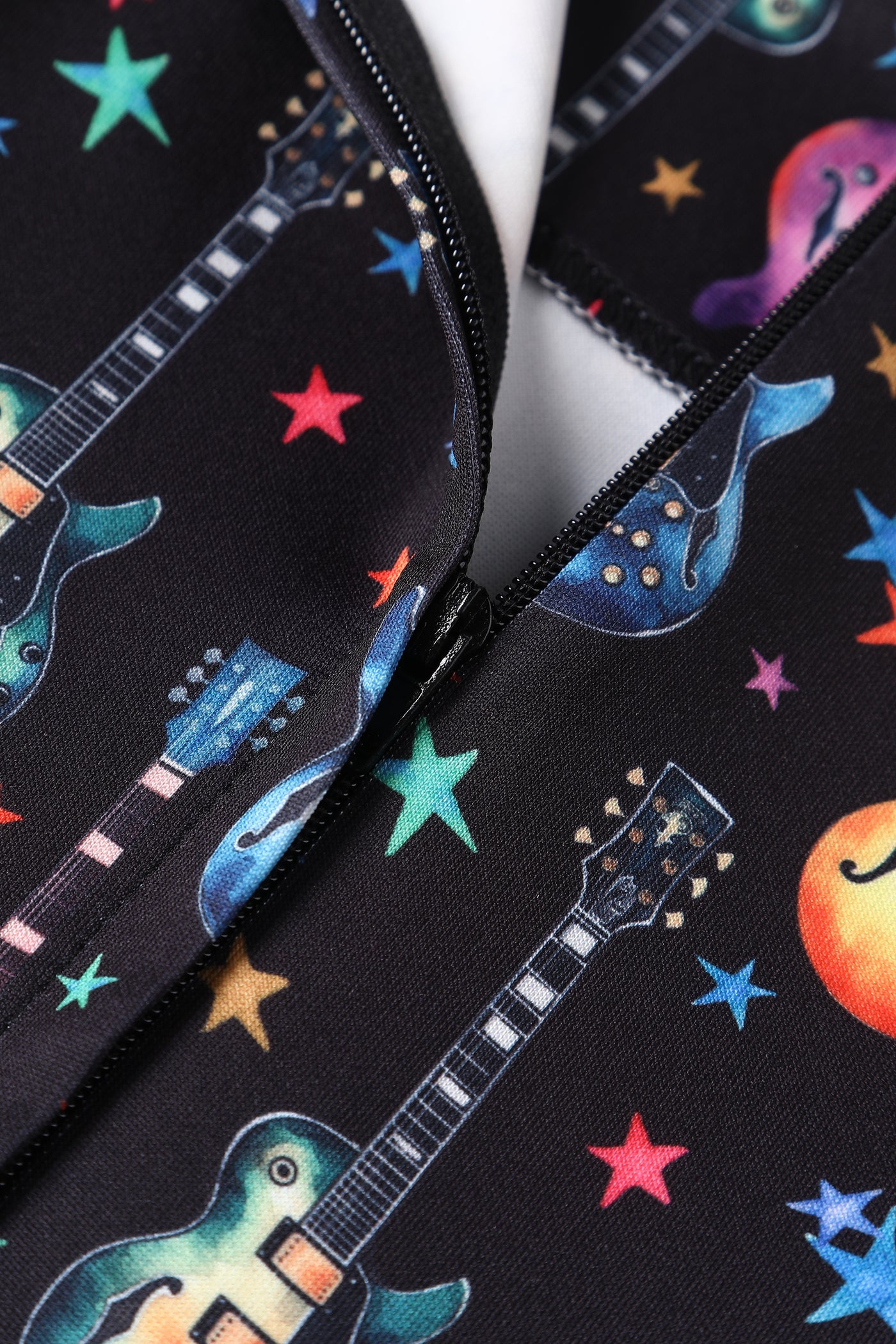 Close up view of Black Pleated Dress in Guitar & Stars Print