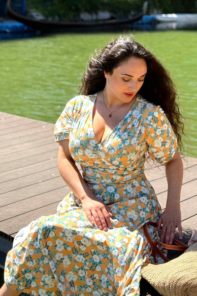 A model photo in a Rosaceae Floral Midi Dress In Yellow