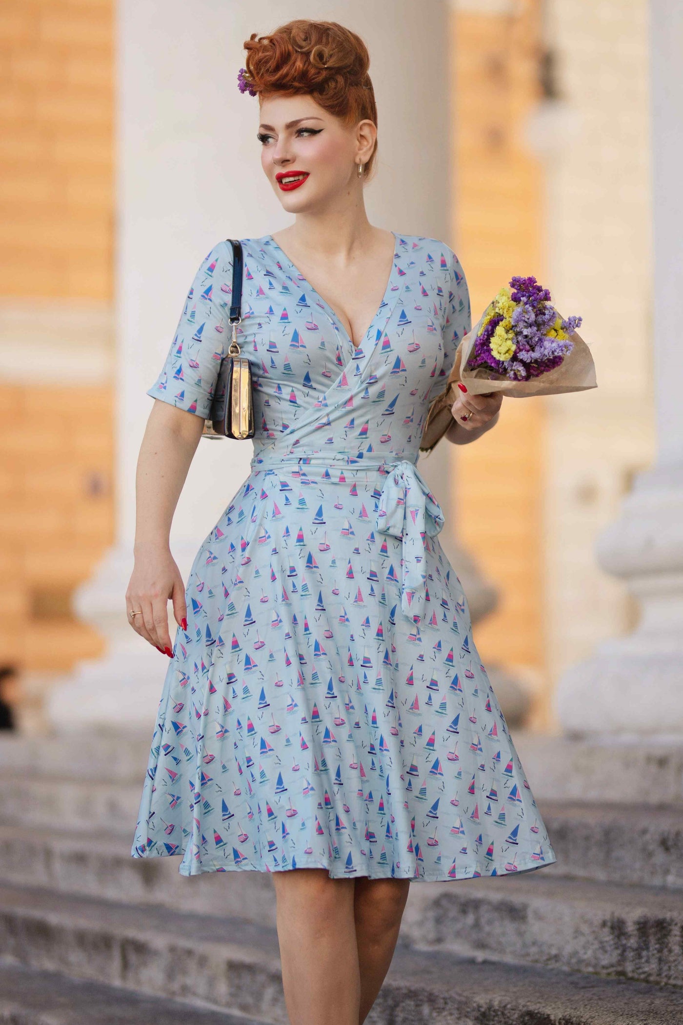 Model photo wearing a Sailboat Blue Wrap Dress