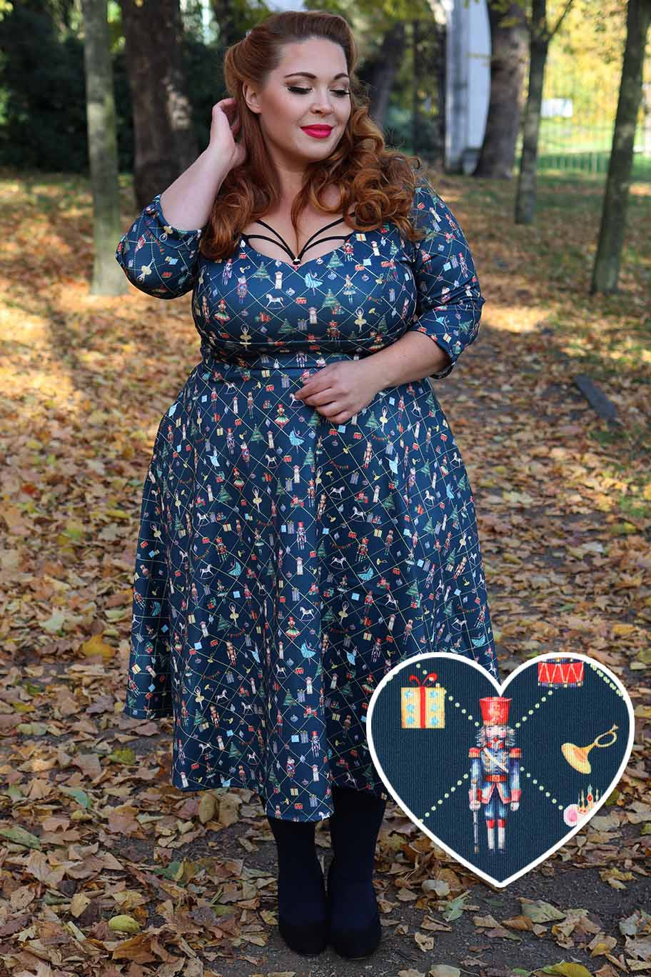 A model wearing a Scarlette Christmas Nutcrackers Midi Dress In Navy Blue