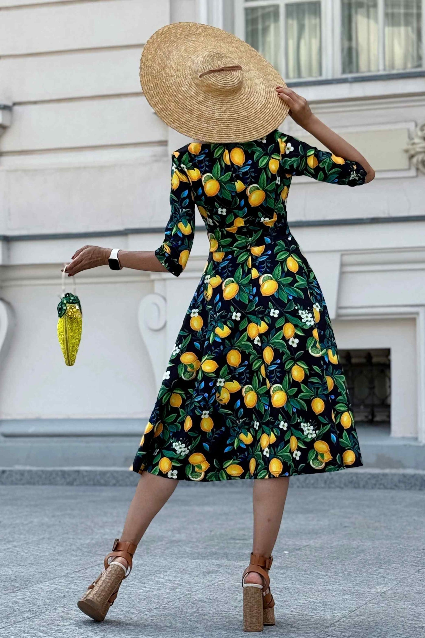 Back view of A model wearing a Lemon Midi Dress In Dark Blue