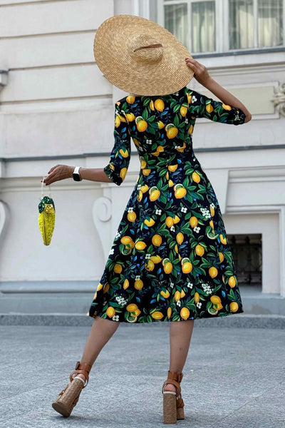 Back view of A model wearing a Lemon Midi Dress In Dark Blue