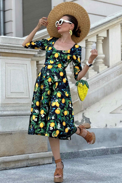 A lady wearing a Scarlette Lemon Midi Dress In Dark Blue
