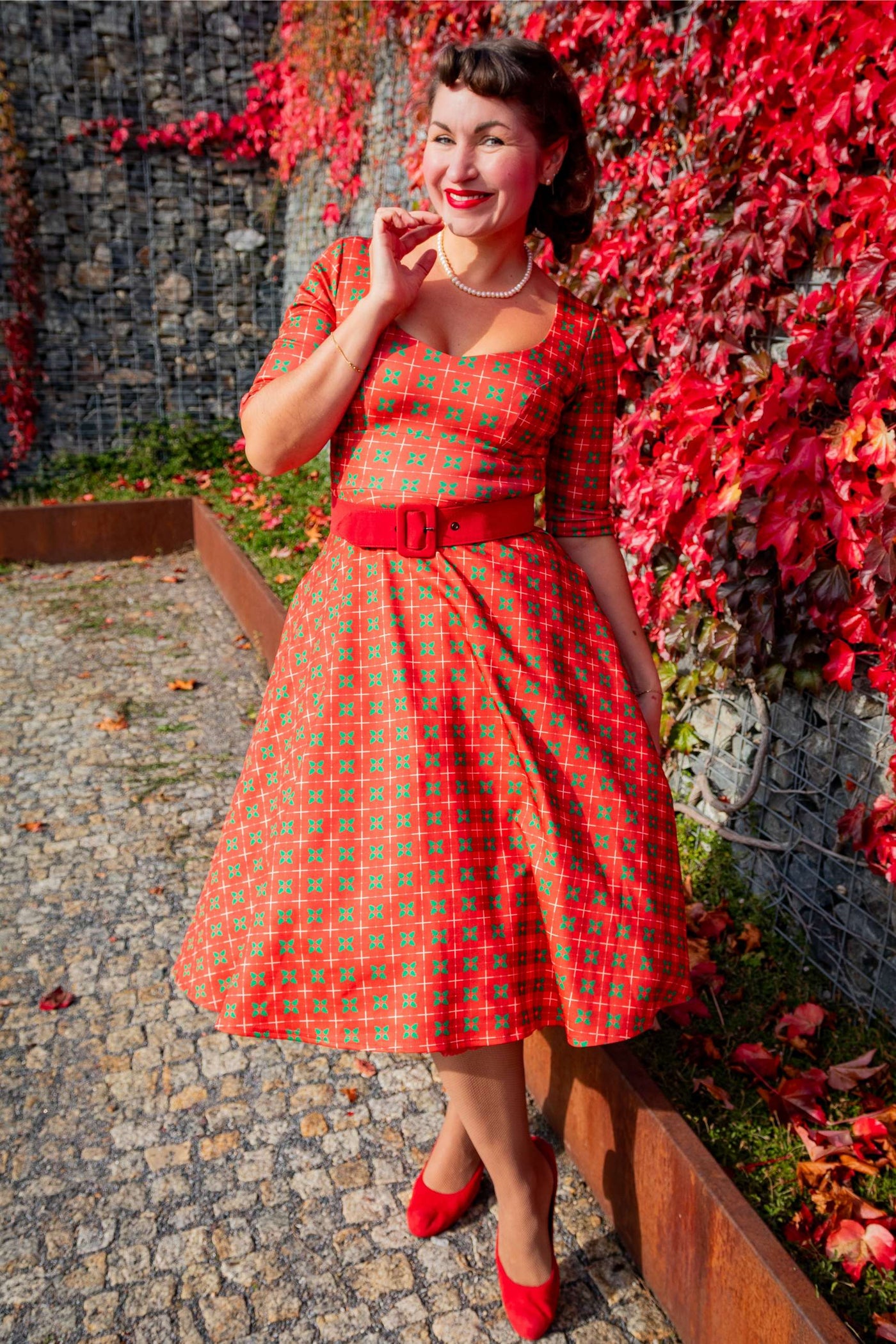 A woman wearing a Scarlette Mistletoe Plaid Midi Dress