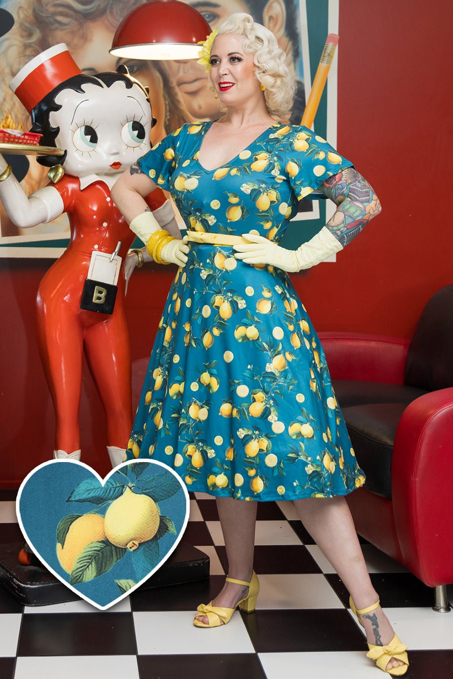 Model wearing Short Sleeved Tea Dress in Teal Blue Lemon Print
