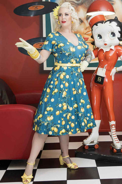 Model wearing Short Sleeved Tea Dress in Teal Blue Lemon Print