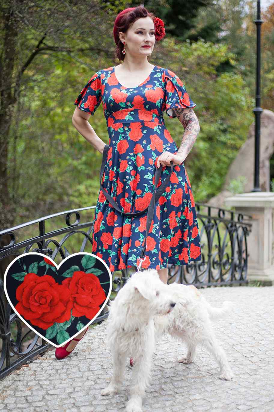 A model wearing a Sleeved Tea Dress in Navy Blue and Red Rose Print