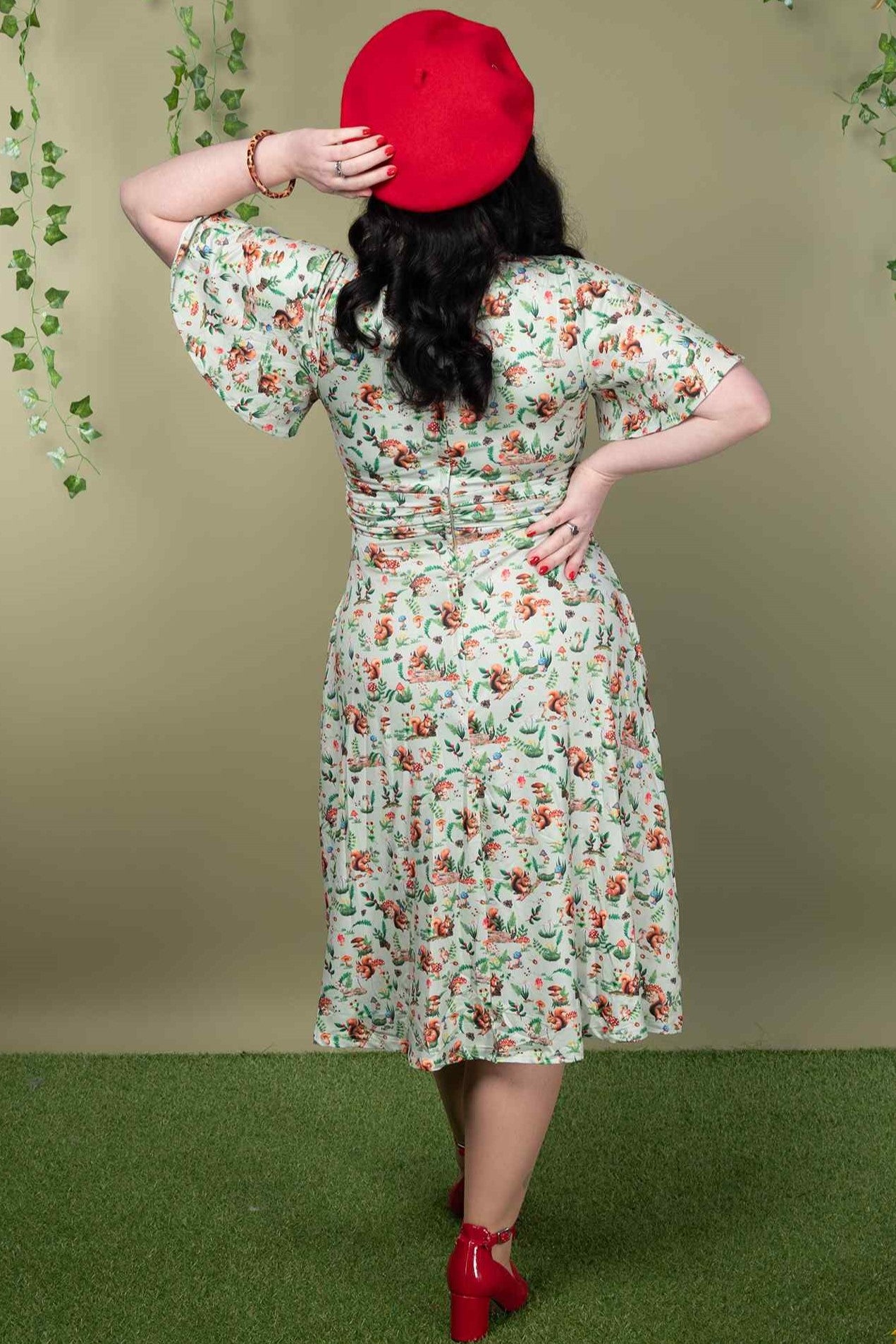 A model wearing a Green Squirrel Woodland Tea Dress