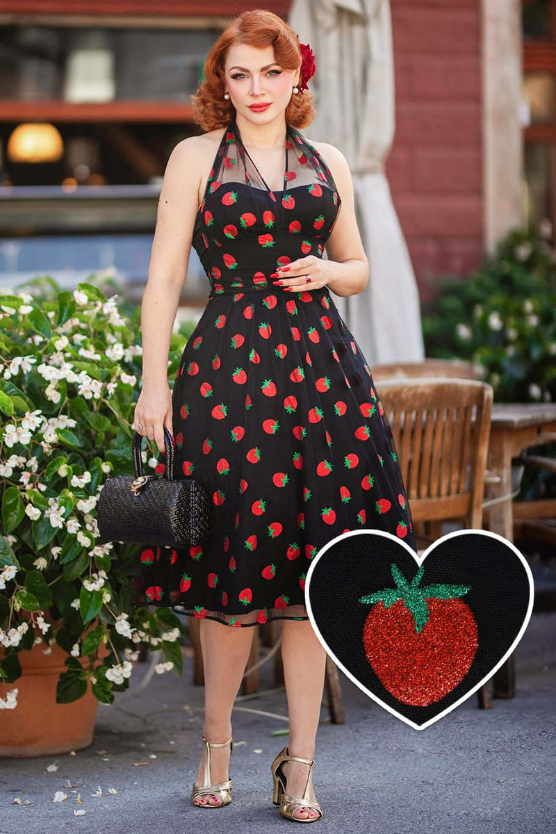 A model wearing a Dorothea Strawberry Black Mesh Halter Dress