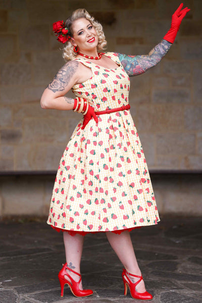 A lady wearing a Strawberry Yellow Gingham Flared Dress