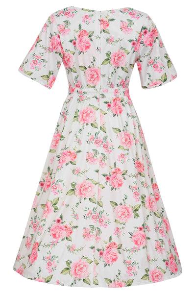 Back view of short sleeved tea dress, in white/pink floral rose print