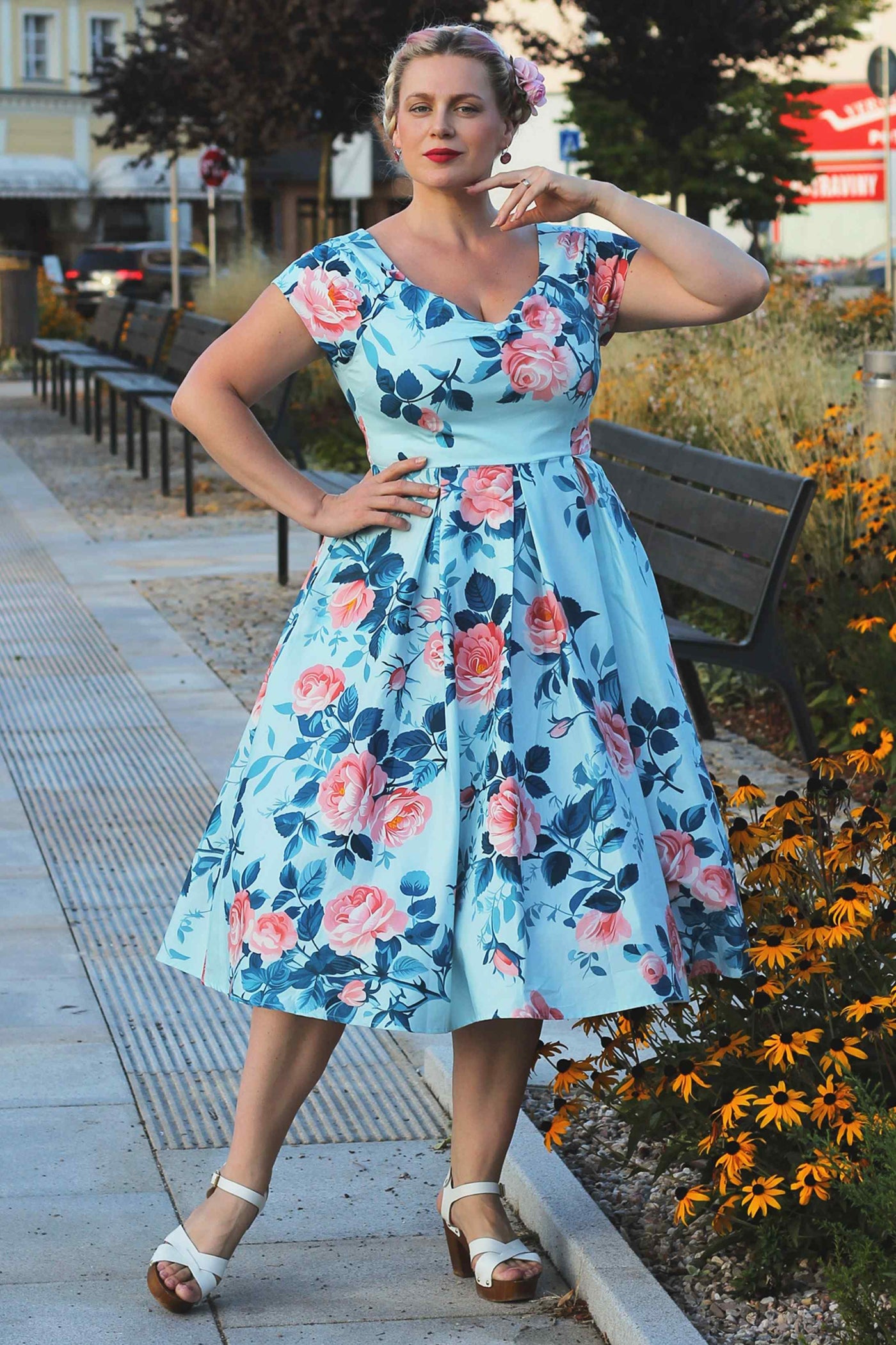A lovely model wearing a Lily Summer Rose Off Shoulder Dress In Light Blue