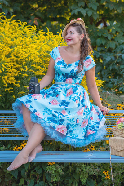 A model wearing a Summer Rose Off Shoulder Dress In Light Blue