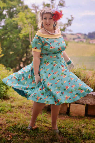 Model wearing Turquoise Pinup Swing Dress in Tropical Island Print