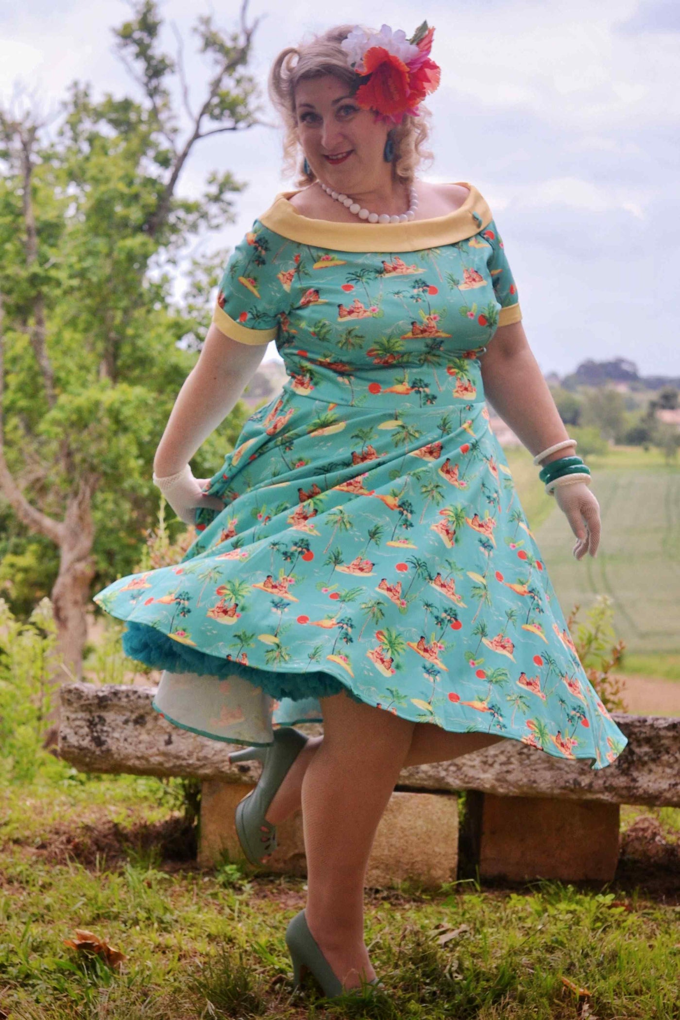 Model wearing Turquoise Pinup Swing Dress in Tropical Island Print