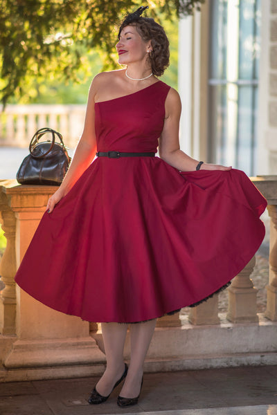 A model wearing a Susan One Shoulder Red Blue Swing Dress