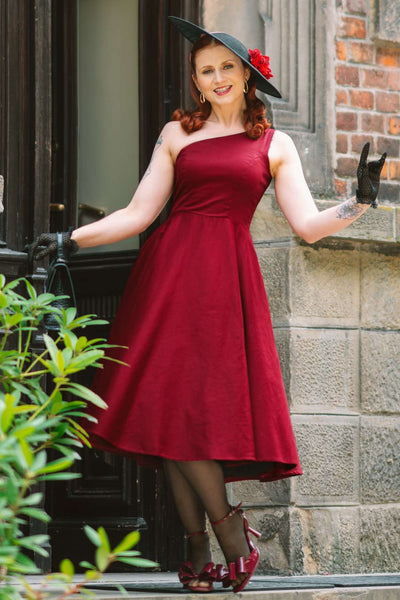 A charming model wearing a Susan One Shoulder Red Blue Swing Dress