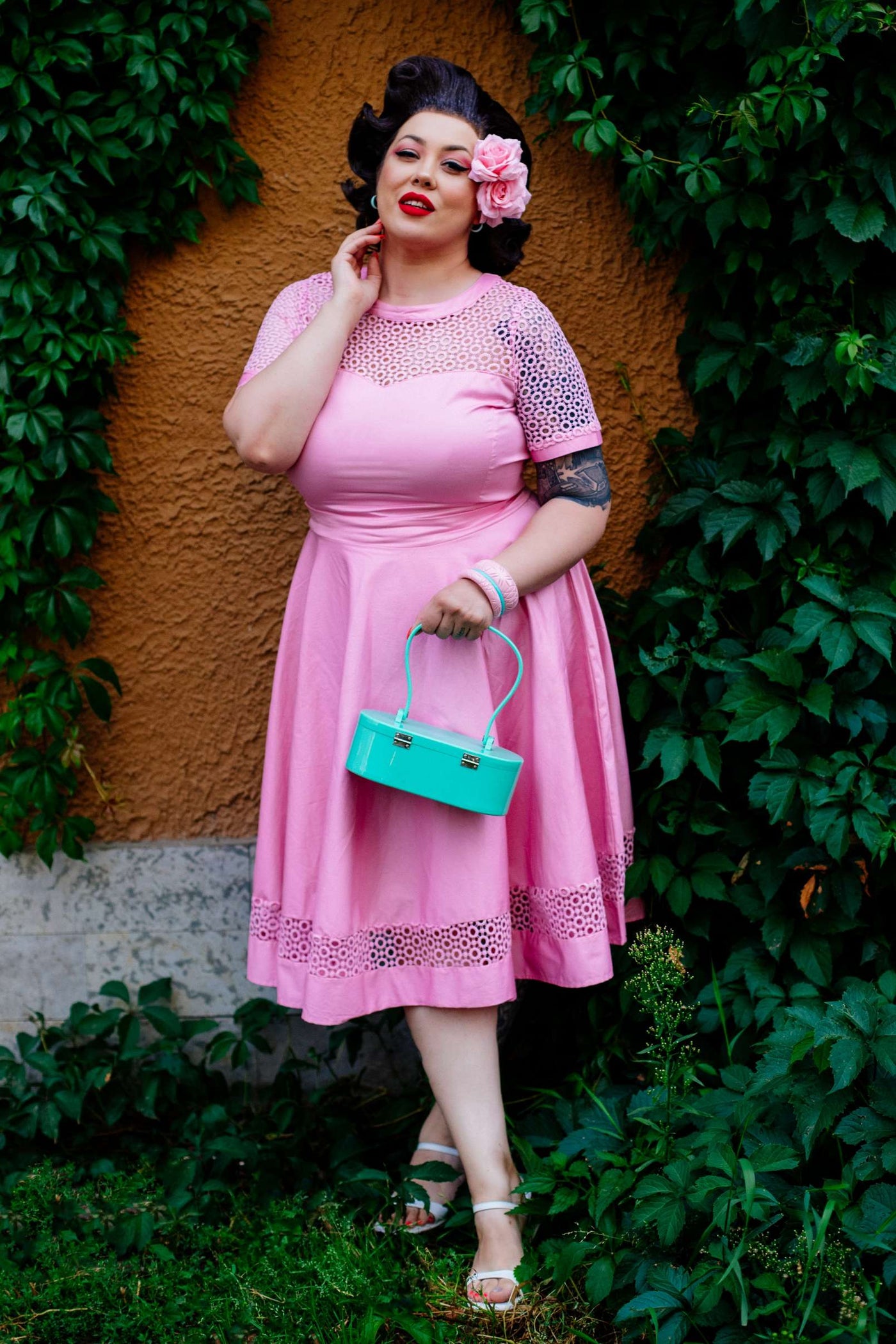 A graceful woman wearing a Crochet Lace Formal Dress In Light Pink