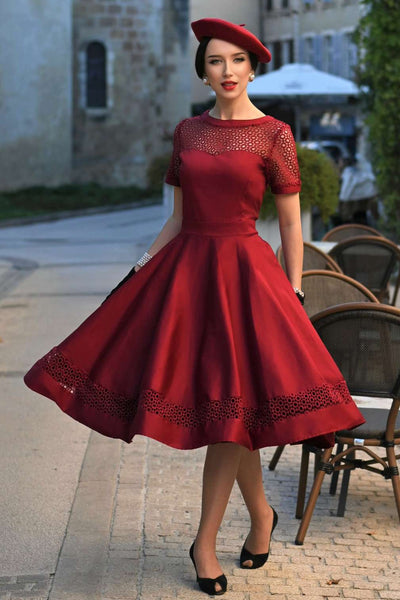 A model wearing a Tess Lace Sleeved Dress in Burgundy