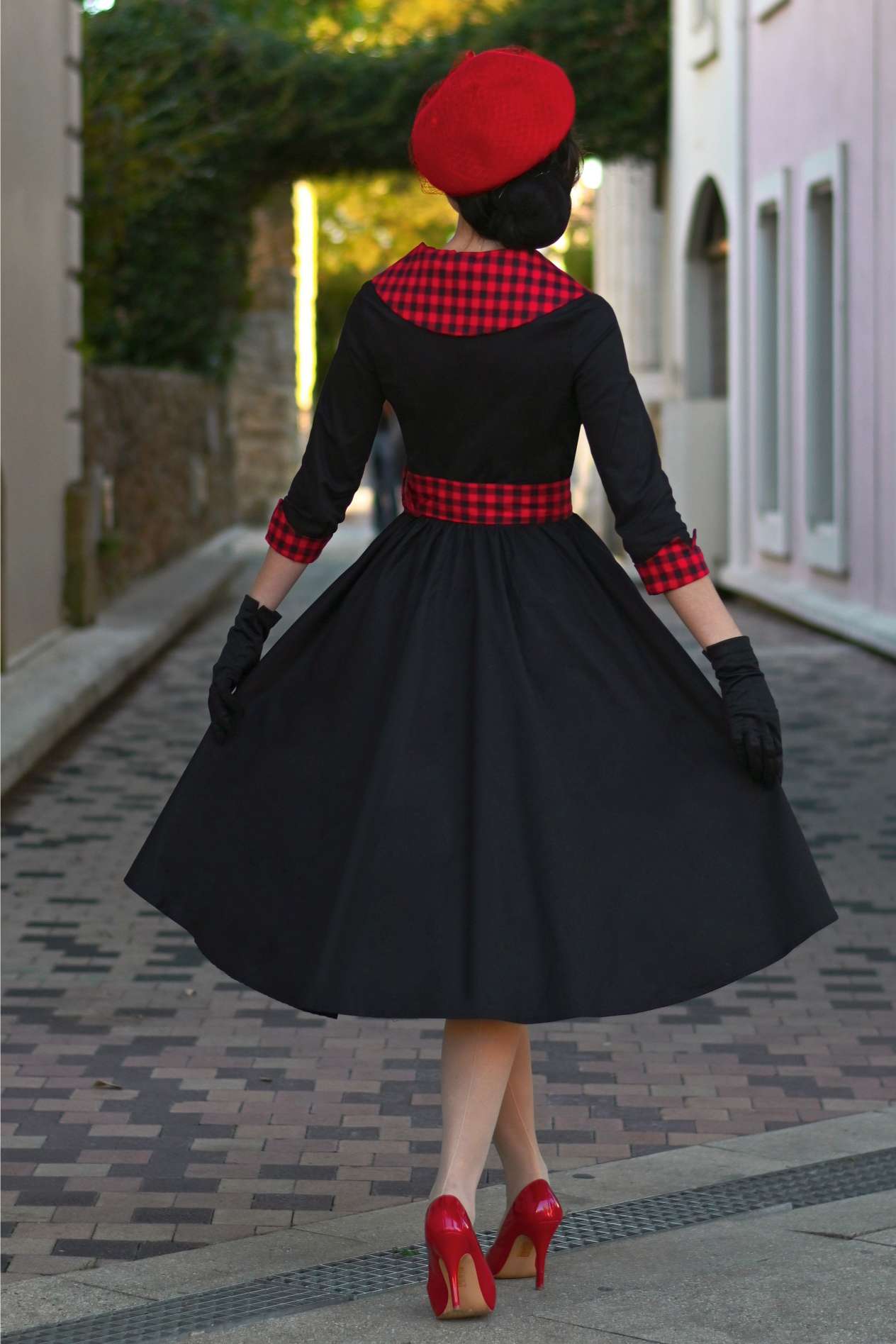 A beautiful model wearing a Tiffany Black Coat Dress With Red Check