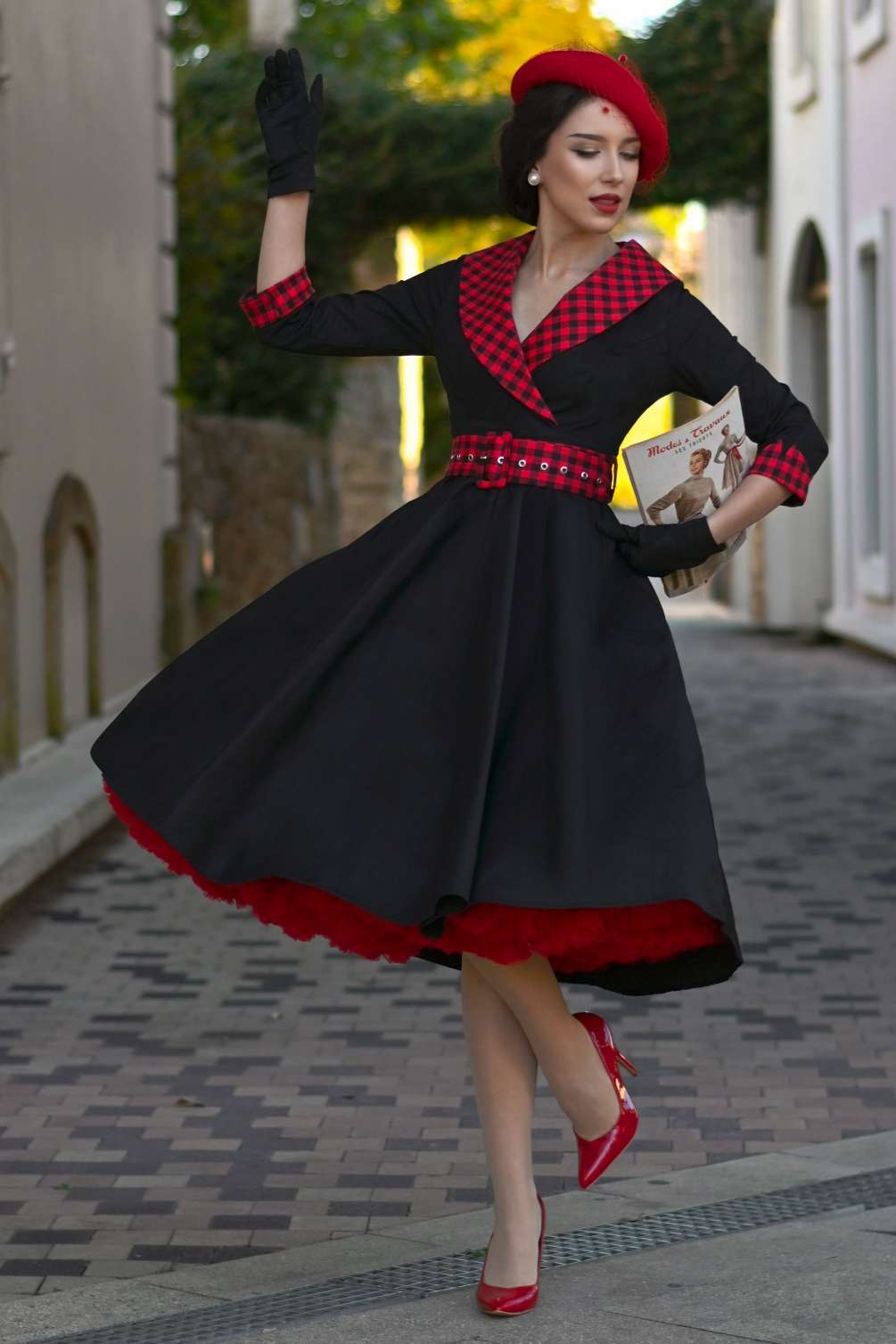 A lovely model wearing a Tiffany Black Coat Dress With Red Check