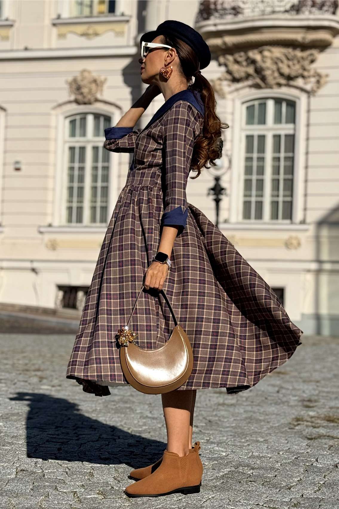 A woman wearing a Tiffany Navy Tartan Coat Dress