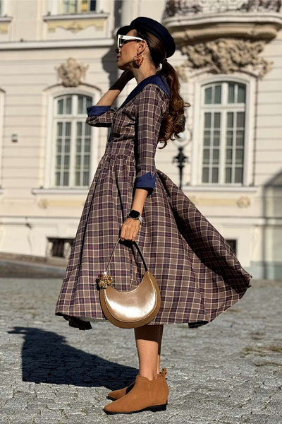 A woman wearing a Tiffany Navy Tartan Coat Dress