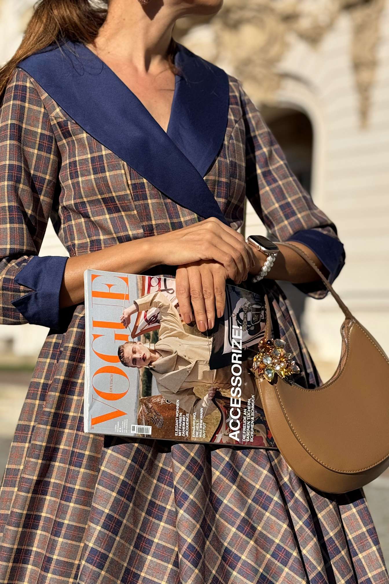 Close up view of a lady wearing a Tiffany Navy Tartan Coat Dress
