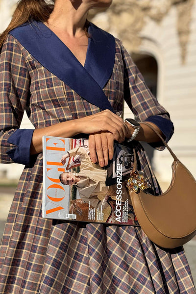 Close up view of a lady wearing a Tiffany Navy Tartan Coat Dress