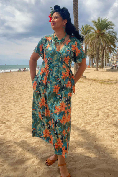 A lovely model wearing an Isla Tiki Toucan Maxi Wrap Dress