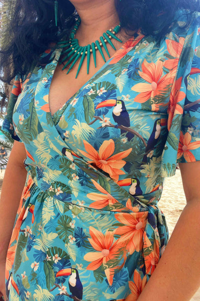 Close up view of a model wearing an Isla Tiki Toucan Maxi Wrap Dress