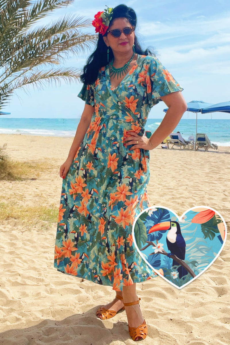 A model wearing an Isla Tiki Toucan Maxi Wrap Dress