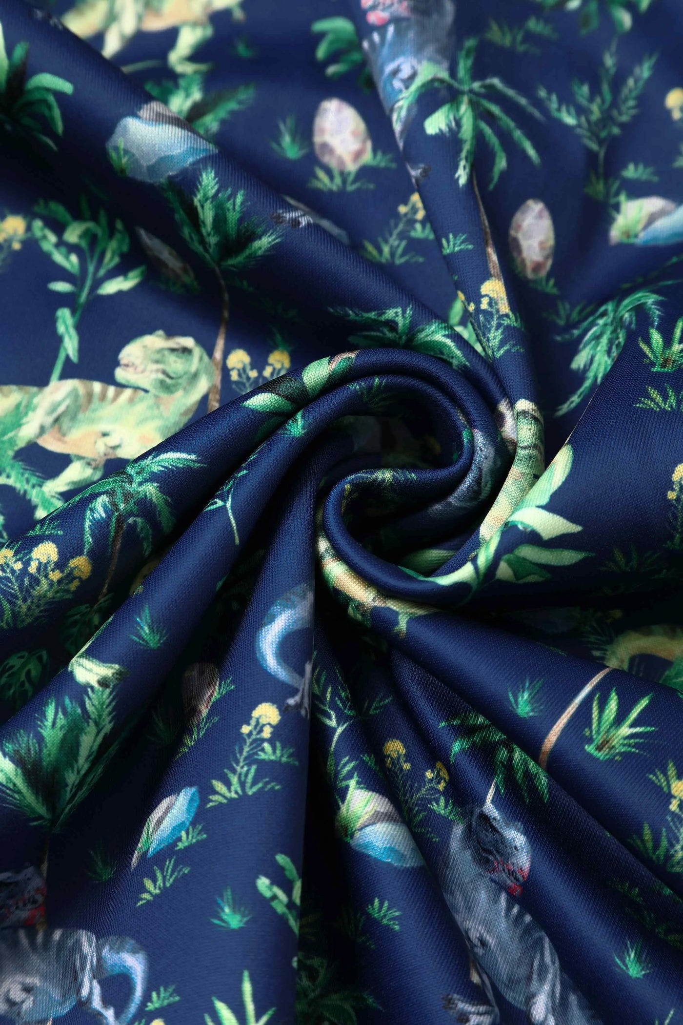 T-rex dinosaur print dress in navy blue fabric close up