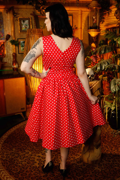 A model wearing a V-neck 50s Style Swing Dress in Red Polka