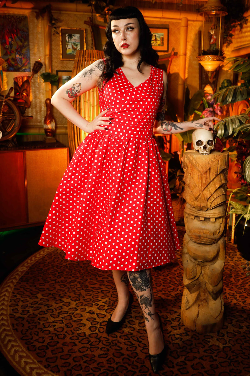 A model wearing a V-neck 50s Style Swing Dress in Red Polka
