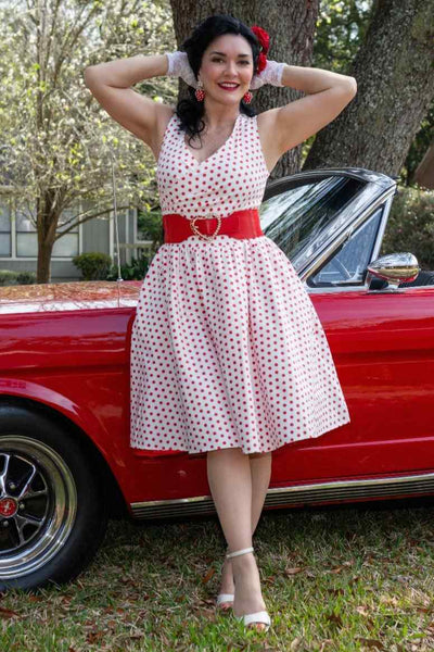 A lady wearing a V Neck White and Red Polka Dot Dresses