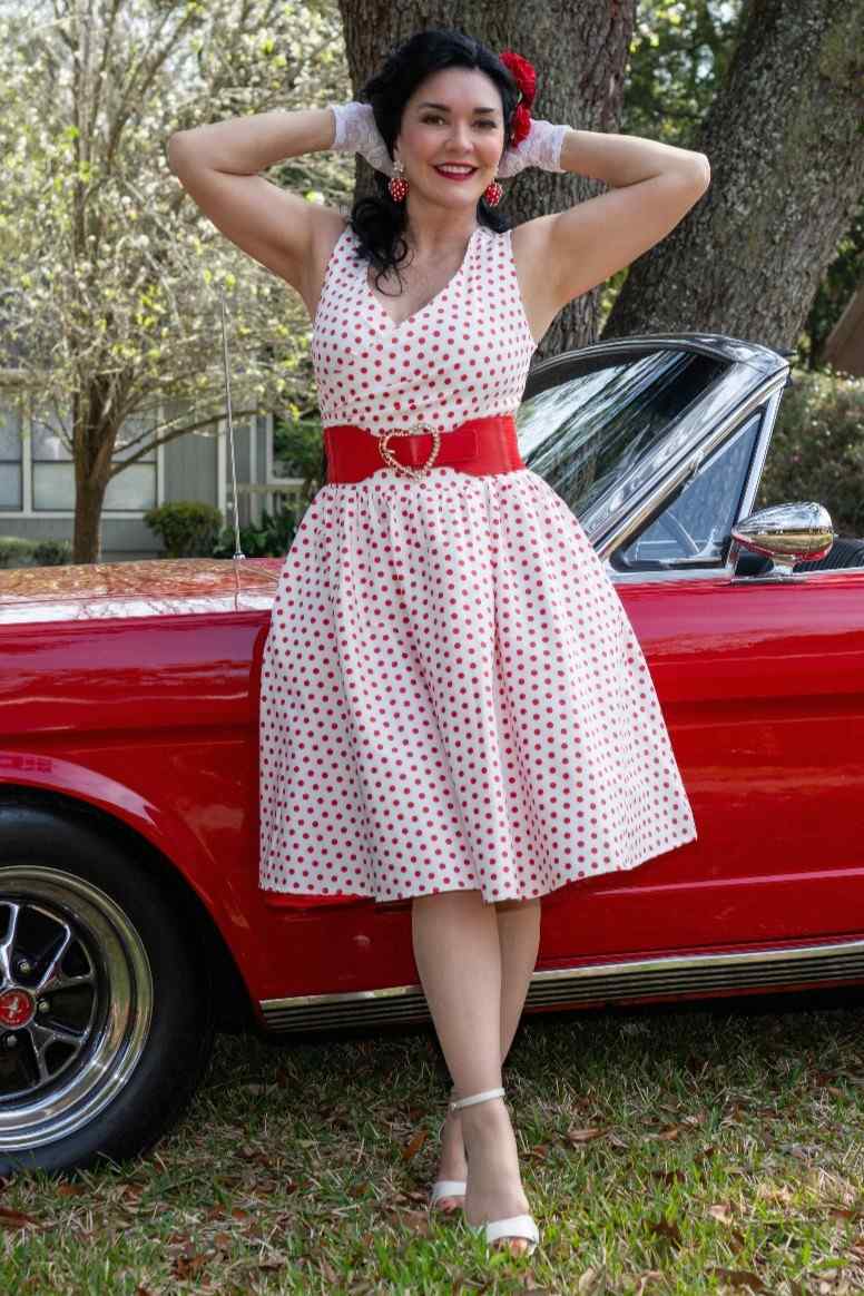 A lady wearing a V Neck White and Red Polka Dot Dresses