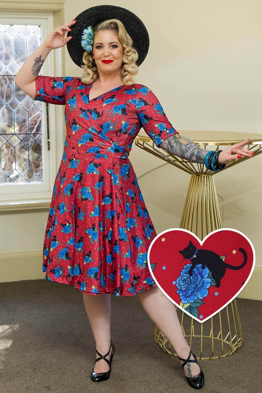 A model wearing a Matilda Vintage Black Cat & Rose  Wrap Dress In Red