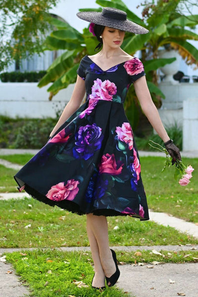 A lady wearing a Lily Peony Garden Off Shoulder Dress